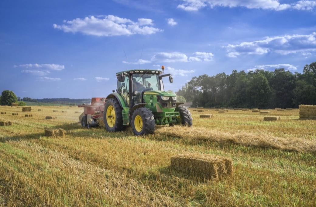 Tractor working a field at the end of the row